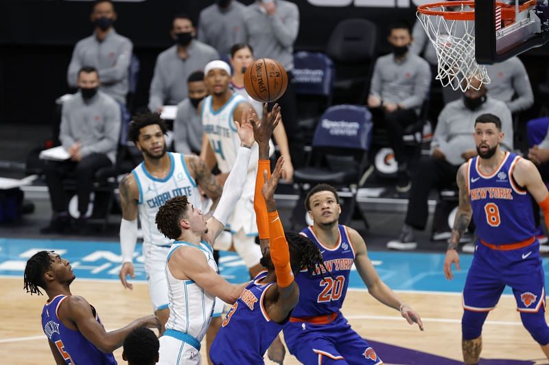 LaMelo Ball (#2) of the Charlotte Hornets attempts a layup against Nerlens Noel (#3) of the New York Knicks.