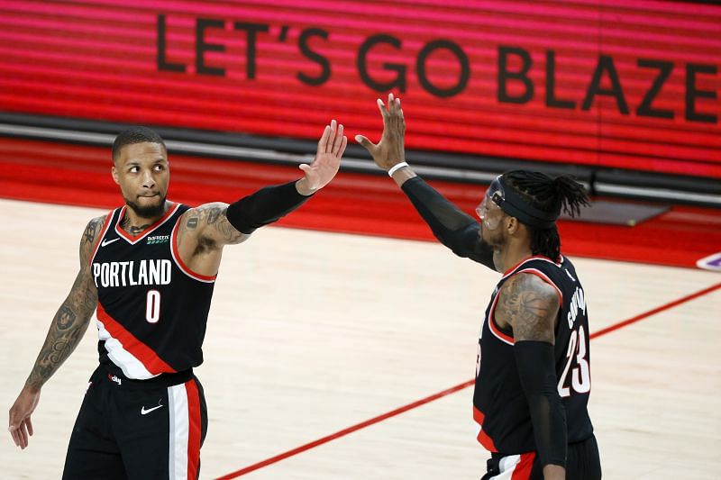 Damian Lillard #0 and Robert Covington #23 high five after a play.