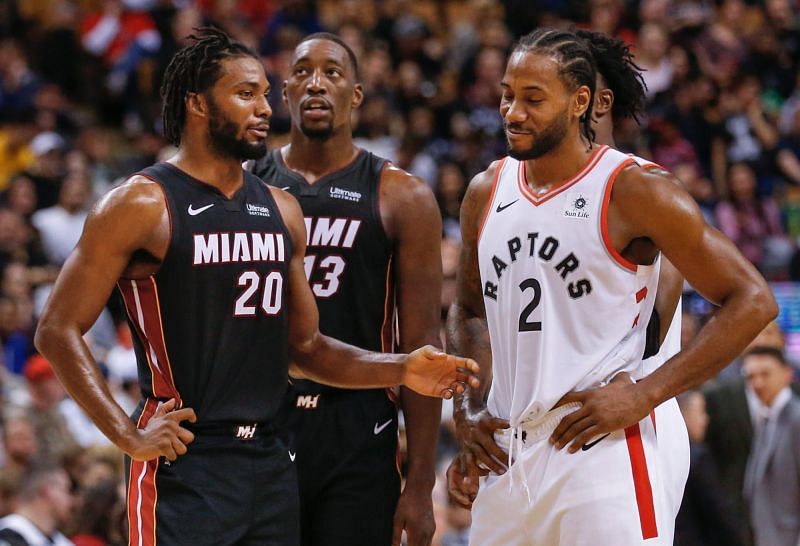 Kawhi Leonard talks with the Miami Heat players