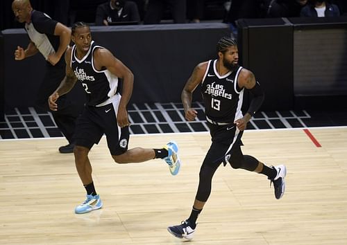 Paul George #13 and Kawhi Leonard #2 run back on defense.