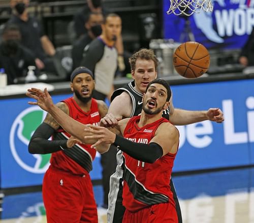 Enes Kanter #11 of the Portland Trailblazers battles Jakob Poeltl #25 of the San Antonio Spurs for a rebound