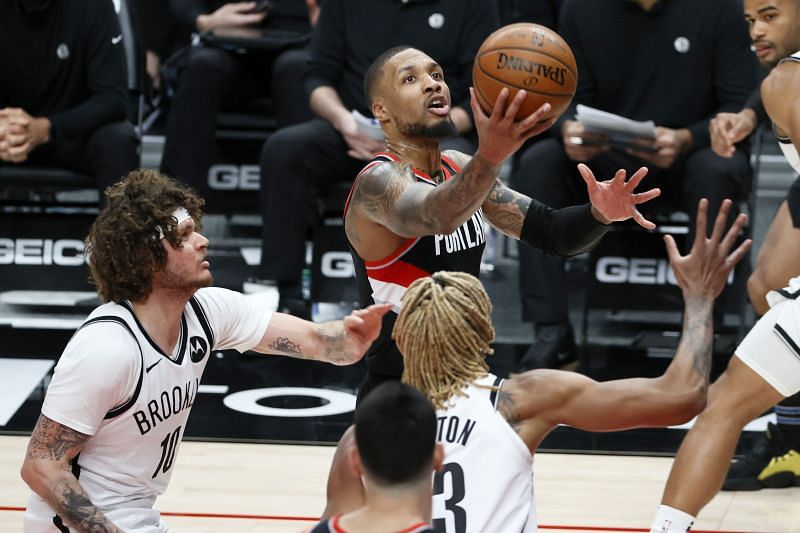 Damian Lillard #0 attempts a lay up against the Brooklyn Nets during the third quarter at Moda Center.