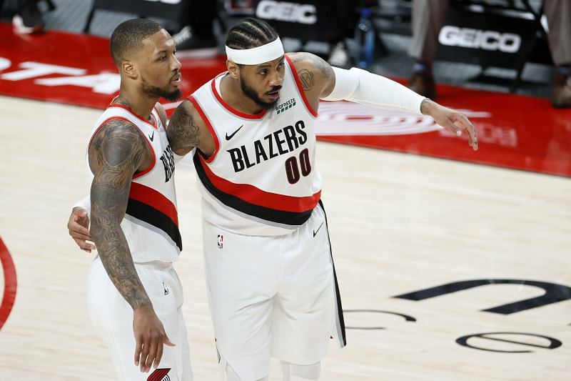 Damian Lillard #0 and Carmelo Anthony #00 talk during the fourth quarter against the Dallas Mavericks.