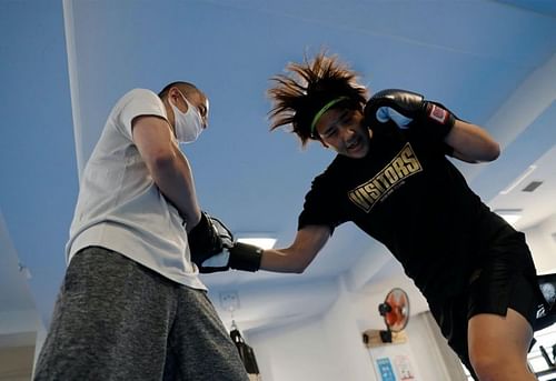 Arisa Tsubata (R) trains with Yuki Yamashita inside the Life Support Clinic. (Source: Reuters)