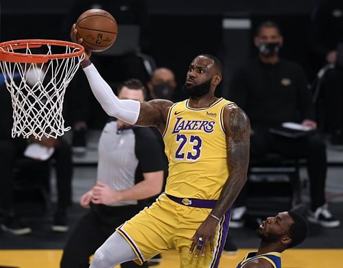 LeBron James #23 on a layup past Andrew Wiggins #22.