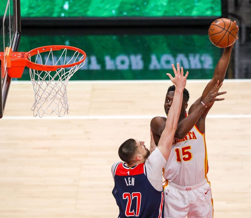 Clint Capela #15 takes a shot as Alex Len #27.