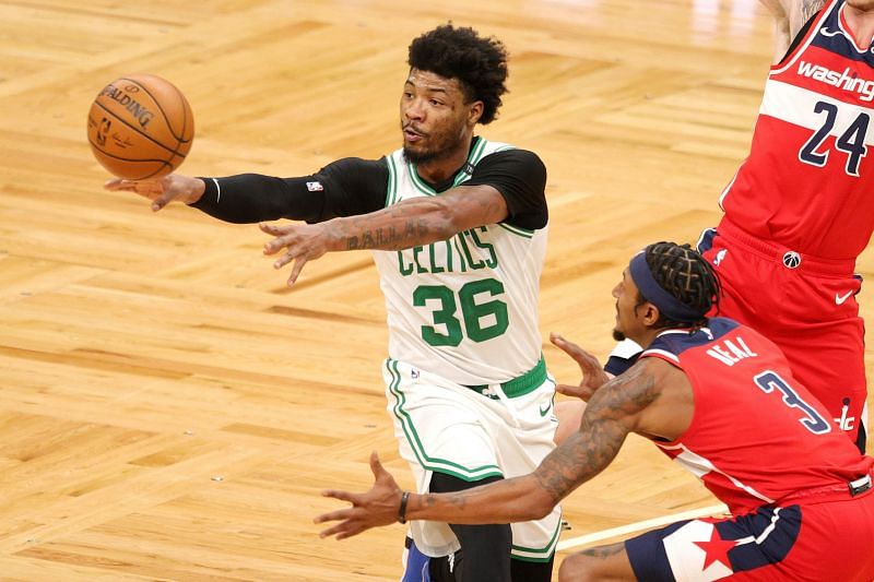 Marcus Smart #36 of the Boston Celtics makes a pass around Bradley Beal #3 of the Washington Wizards