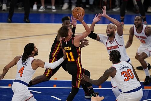 Derrick Rose (left) pushes Trae Young (11) as he drives to the basket