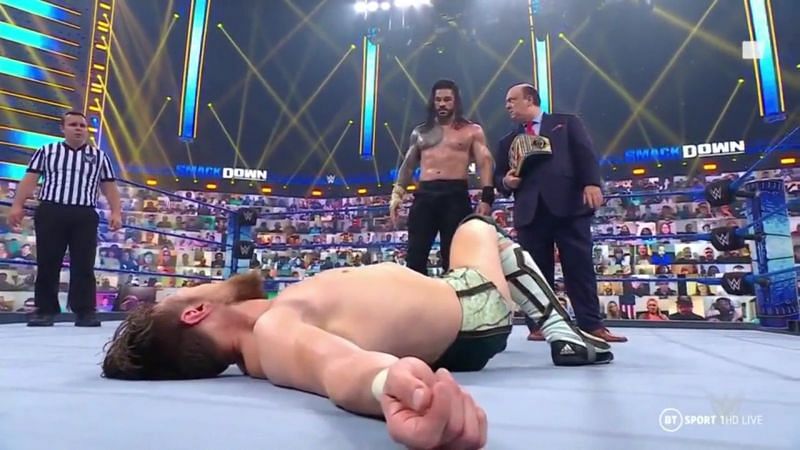 Roman Reigns with a fallen Daniel Bryan