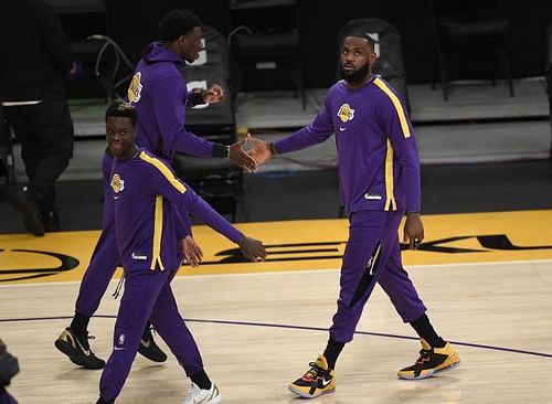 LeBron James (#23) is welcomed by Devontae Cacok (#12) during pre-game warm-ups.