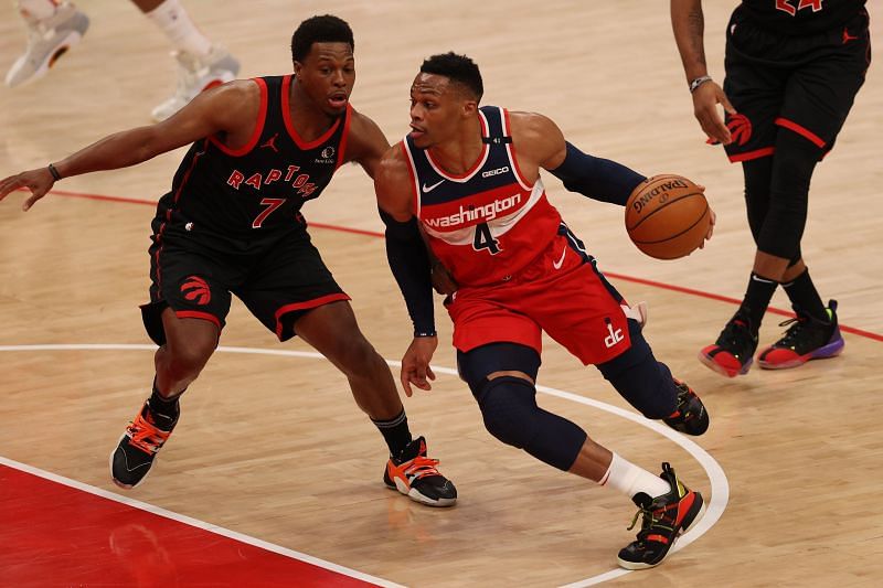 Russell Westbrook #4 dribbles in front of Kyle Lowry #7.