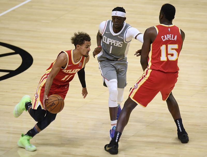 Trae Young (#11) of the Atlanta Hawks uses Clint Capela (#15) as a screen on Reggie Jackson (#1) of the LA Clippers