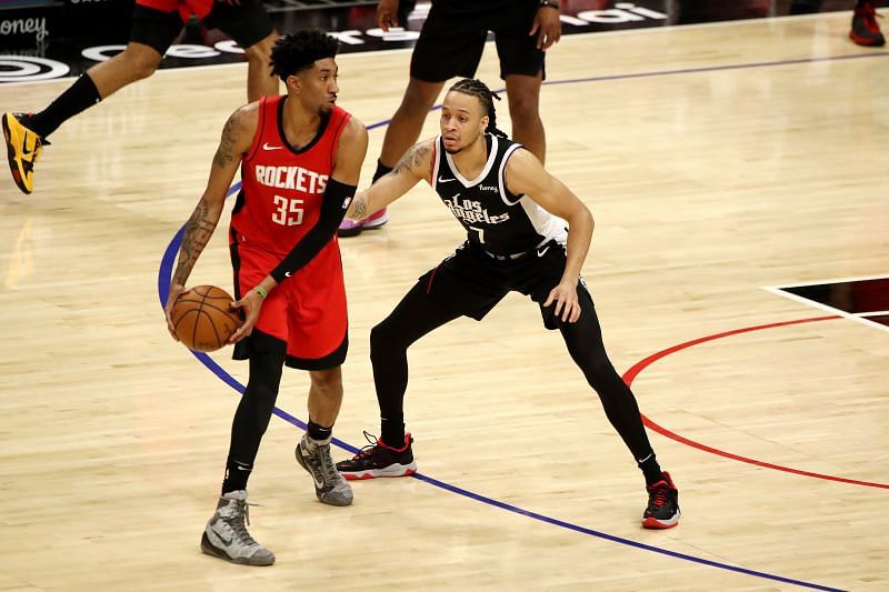 Christian Wood #35 looks to pass the ball against Amir Coffey #7.