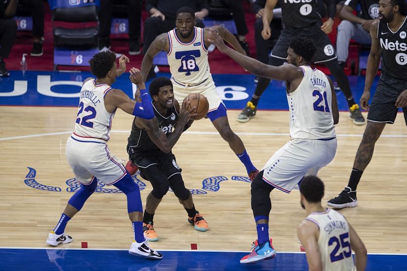 Joel Embiid and Matisse Thybulle of the Philadelphia 76ers guard Kyrie Irving of the Brooklyn Nets