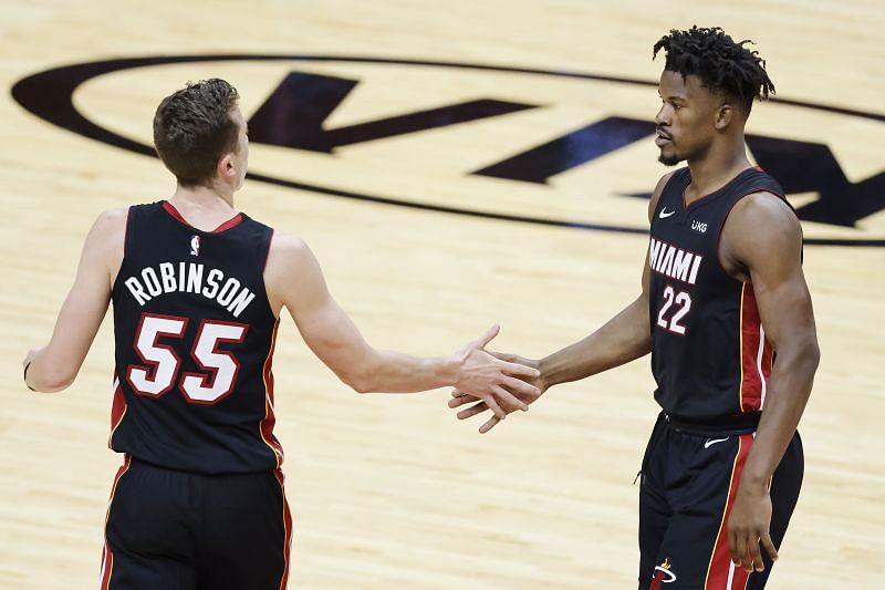 Duncan Robinson #55 of the Miami Heat celebrates a three pointer with Jimmy Butler.