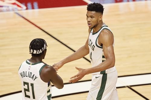 Giannis Antetokounmpo #34 of the Milwaukee Bucks high fives Jrue Holiday.