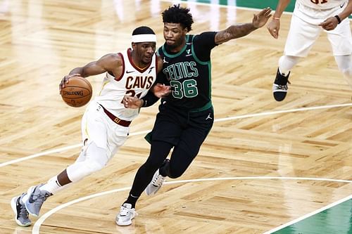 Damyean Dotson #21 drives against Marcus Smart #36