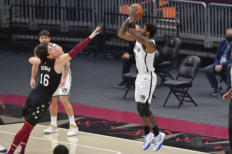 Kyrie Irving of the Brooklyn Nets shoots over Cedi Osman of the Cleveland Cavaliers
