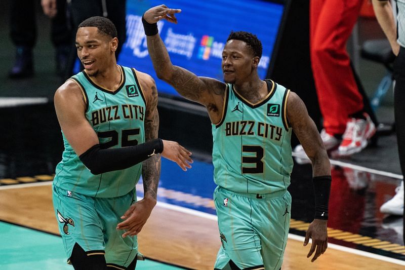 Terry Rozier #3 of the Charlotte Hornets reacts after making a three point shot assisted by P.J. Washington #25.