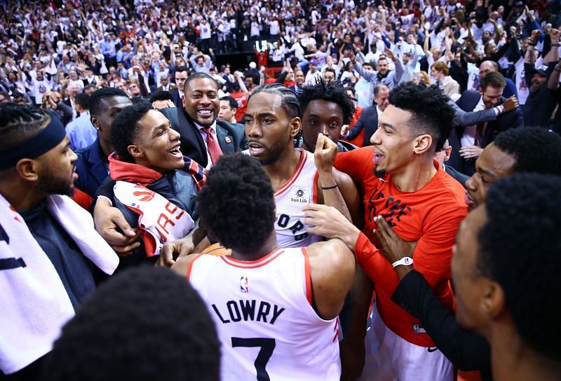 Toronto Raptors players swarm Kawhi Leonard after buzzer-beater