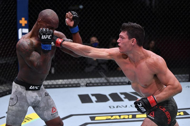 Alan Jouban (right) punches Jared Gooden (left) at the UFC 255 bout