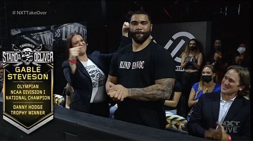 Gable Steveson alongside Stephanie McMahon at NXT TakeOver: Stand & Deliver.