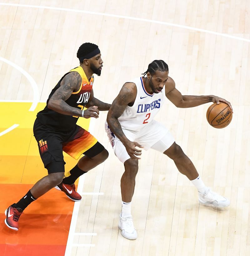 Kawhi Leonard #2 drives against Royce O'Neale #23