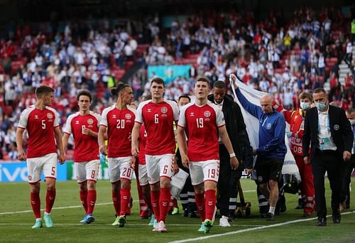 Players accompanying Christian Eriksen off the pitch