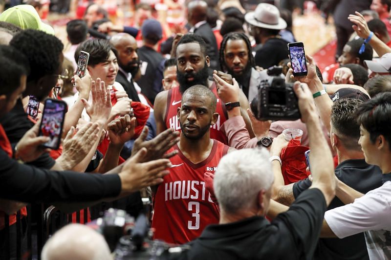 Chris Paul #3 and James Harden #13 walk to the locker room after a playoff game in 2019.