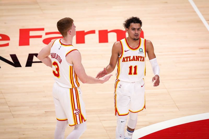 Trae Young #11 low fives Kevin Huerter #3