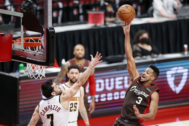 CJ McCollum #3 shoots against Facundo Campazzo #7