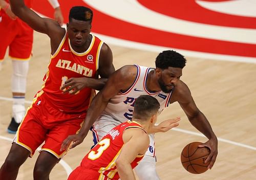 Joel Embiid #21 is defended by Clint Capela #15 and Bogdan Bogdanovic #13