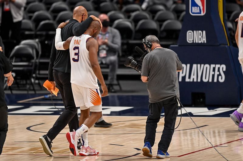 Head coach Monte Williams walks alongside Chris Paul #3