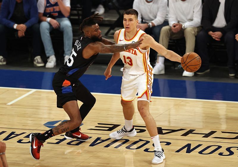 Reggie Bullock of the New York Knicks guards Bogdanovic of the Atlanta Hawks