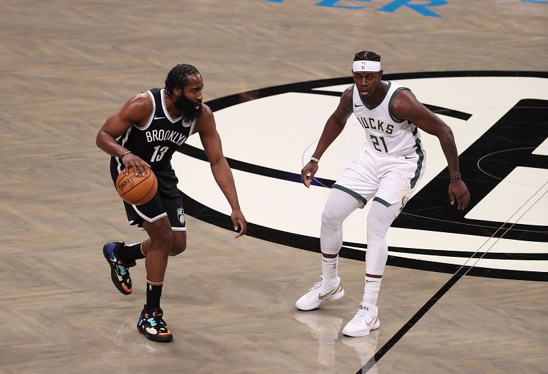 James Harden #13 in action against Jrue Holiday #21