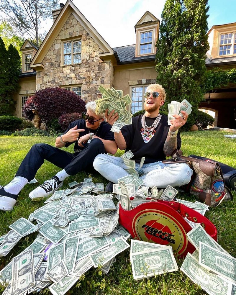Jake Paul (right) celebrates with a stack of cash.