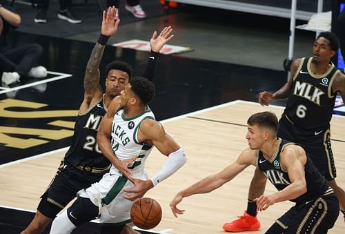 Bogdan Bogdanovic #13 of the Hawks strips the ball from Giannis Antetokounmpo #34 of the Bucks