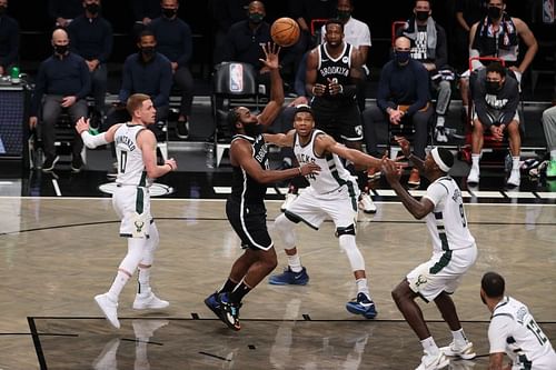 James Harden #13 shoots against Giannis Antetokounmpo #34.