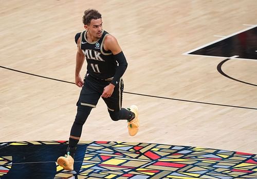 Trae Young #11 reacts after hitting a three-point basket