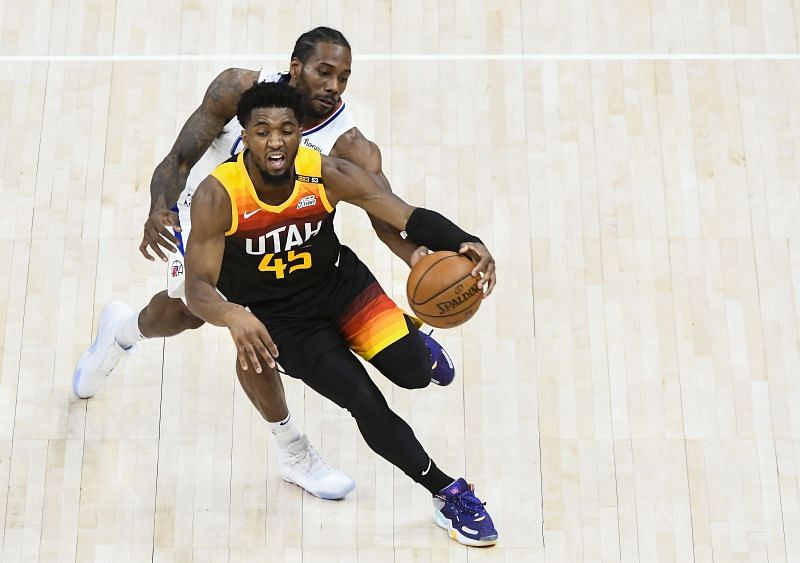 Donovan Mitchell #45 drives in front of Kawhi Leonard #2