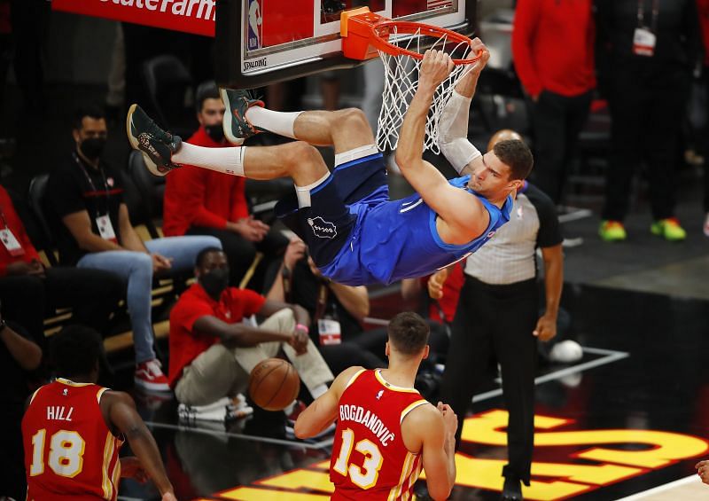 Brook Lopez (#11) of the Milwaukee Bucks hangs on the rim after dunking against the Atlanta Hawks
