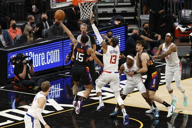 Cameron Payne #15 drives to the basket ahead of Paul George #13