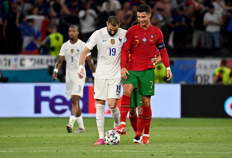 Cristiano Ronaldo and Karim Benzema embrace during the other Group F match between Portugal and France