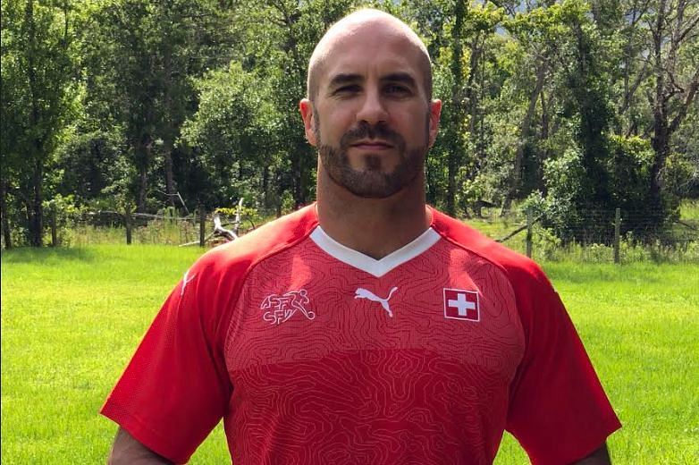 Cesaro sporting the Switzerland football jersey