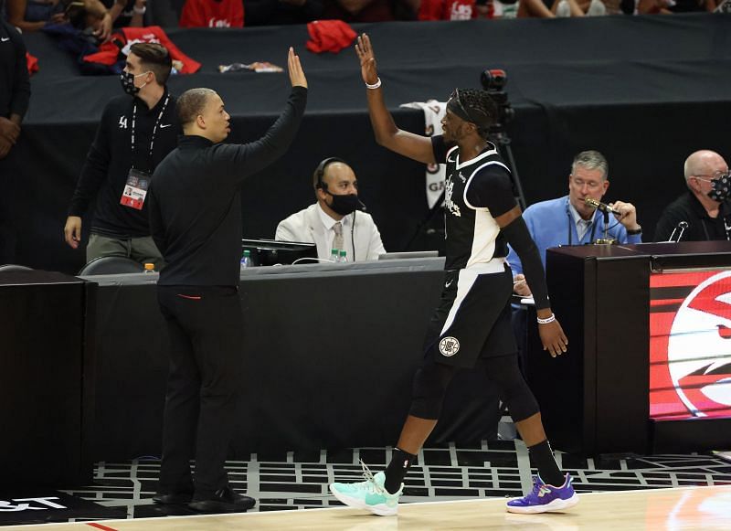 Reggie Jackson #1 is congratulated by head coach Tyronn Lue