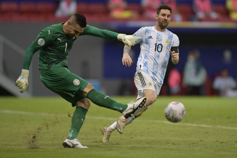 Argentina captain Lionel Messi (right) looks on as Paraguay goalkeeper Antony Silva clears the ball