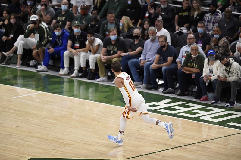 Trae Young #11 celebrates a basket.