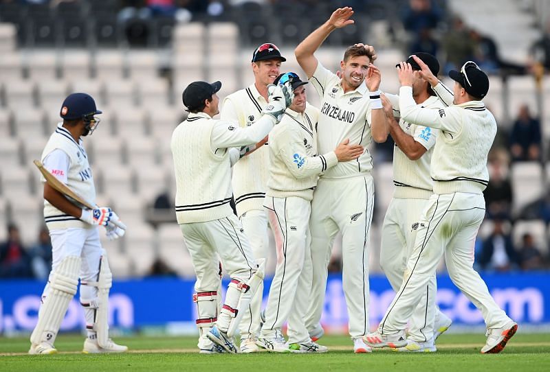 New Zealand team celebrating the fall of a wicket.