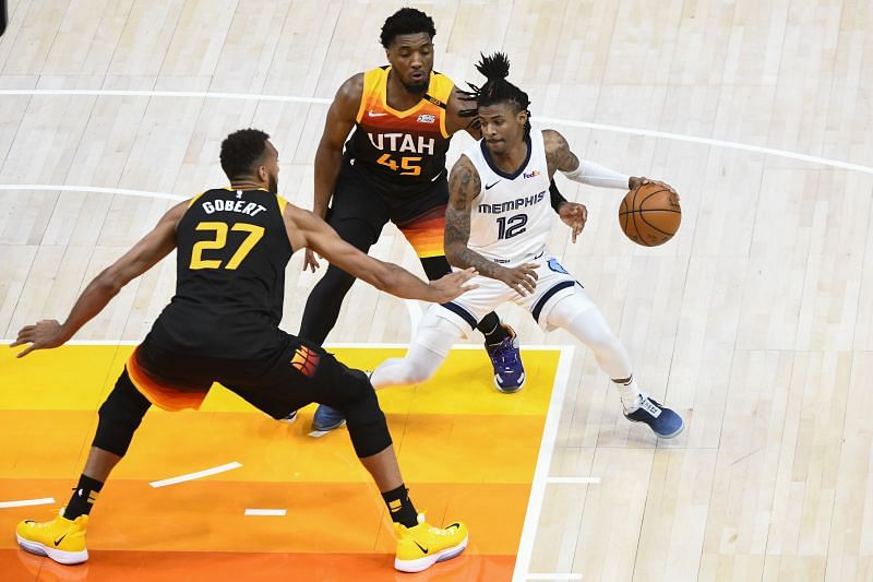 Donovan Mitchell #45 and Rudy Gobert #27 of the Utah Jazz defending Ja Morant #12 of the Memphis Grizzlies