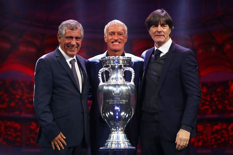 Didier Deschamps (centre) and Joachim Low (right) pose with the European Championship trophy